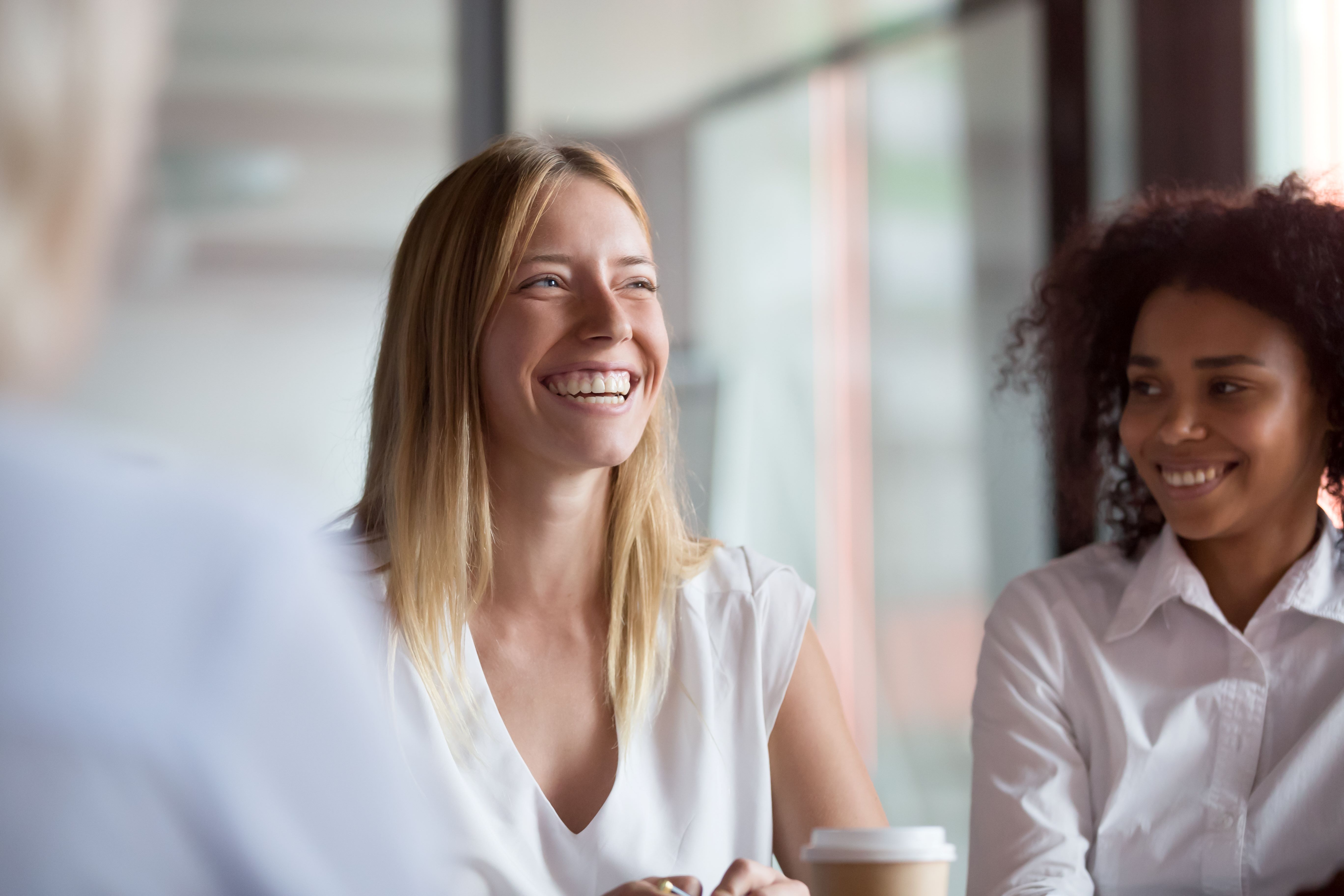 Two women smiling in a meeting situation